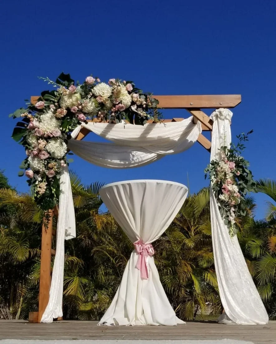wedding reception with enclosed tent, floral backdrop and full table setup in Miami — 1