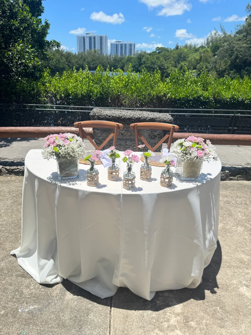wedding reception with enclosed tent, floral backdrop and full table setup in Miami — 3