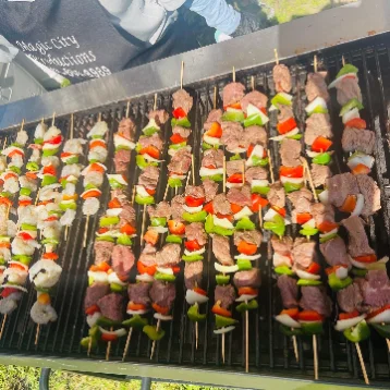 Live grill station cooking steak and chicken at a South Florida party