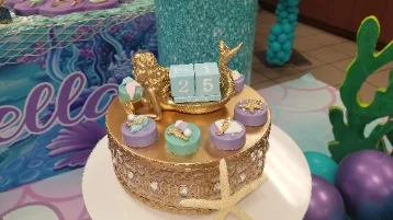 Dessert table with cakes, cupcakes and cake pops at a Miami celebration